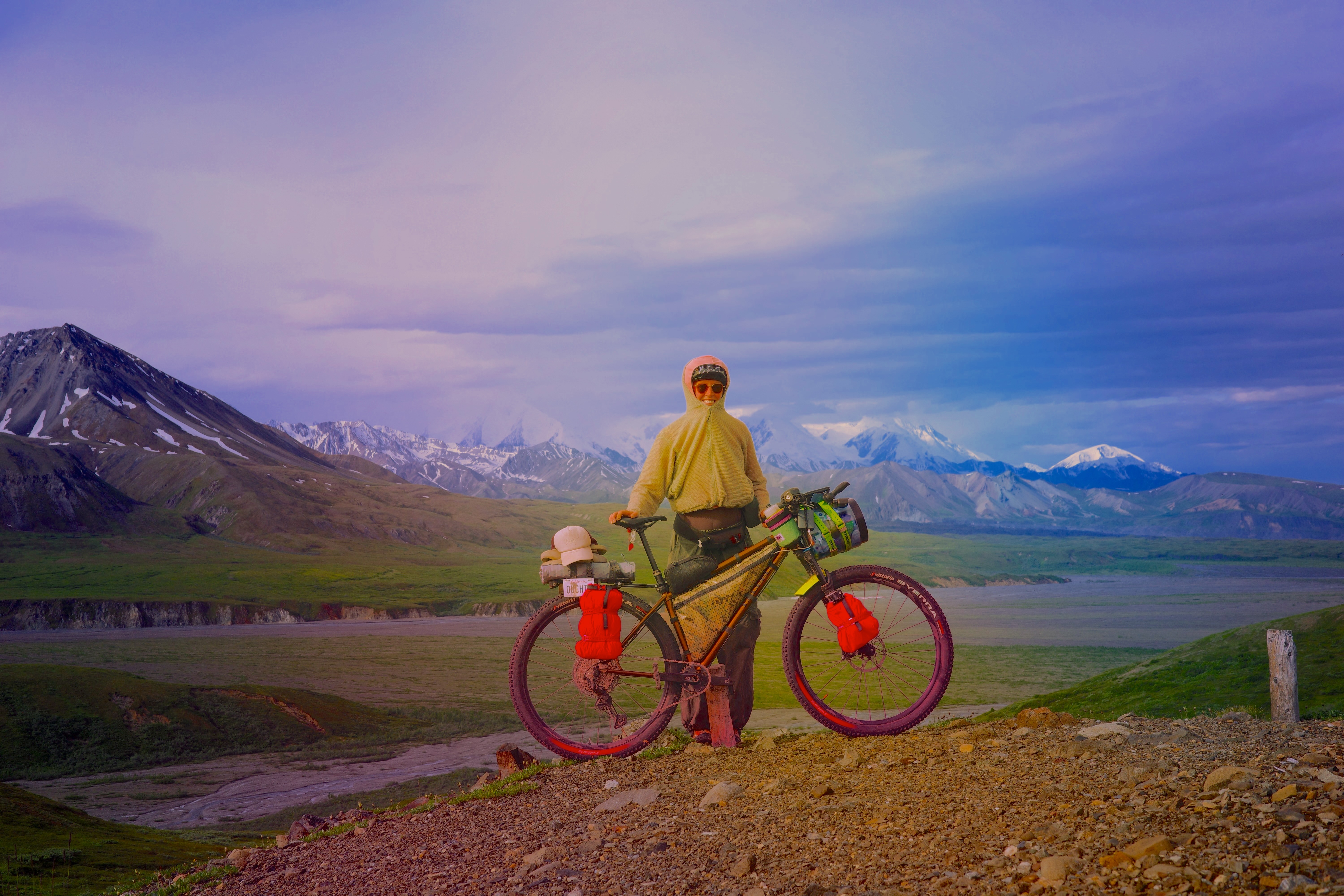 Sarah and her bicycle in the mountains